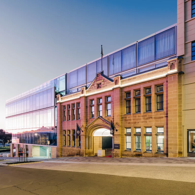 A street side hotel - modern meets traditional in this shot of exposed windows, maintained brick, and an arched opening.