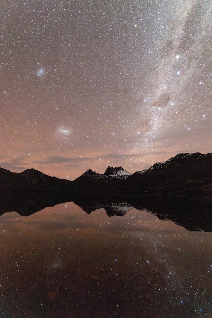 Nightsky over Cradle Mountain and Dove Lake with stars reflected in the water. Luke O'Brien Photography
