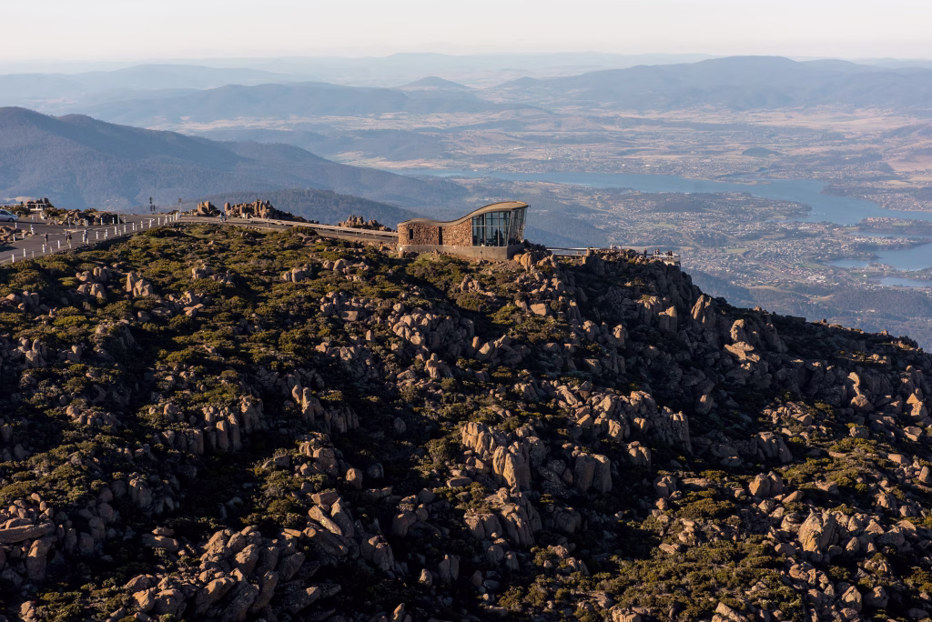 An aerial view of kunanyi / Mount Wellington with the visitor centre and the top lookout point of the mountain visible. Photographer and credit to Events Tasmania and Alastair Bett
